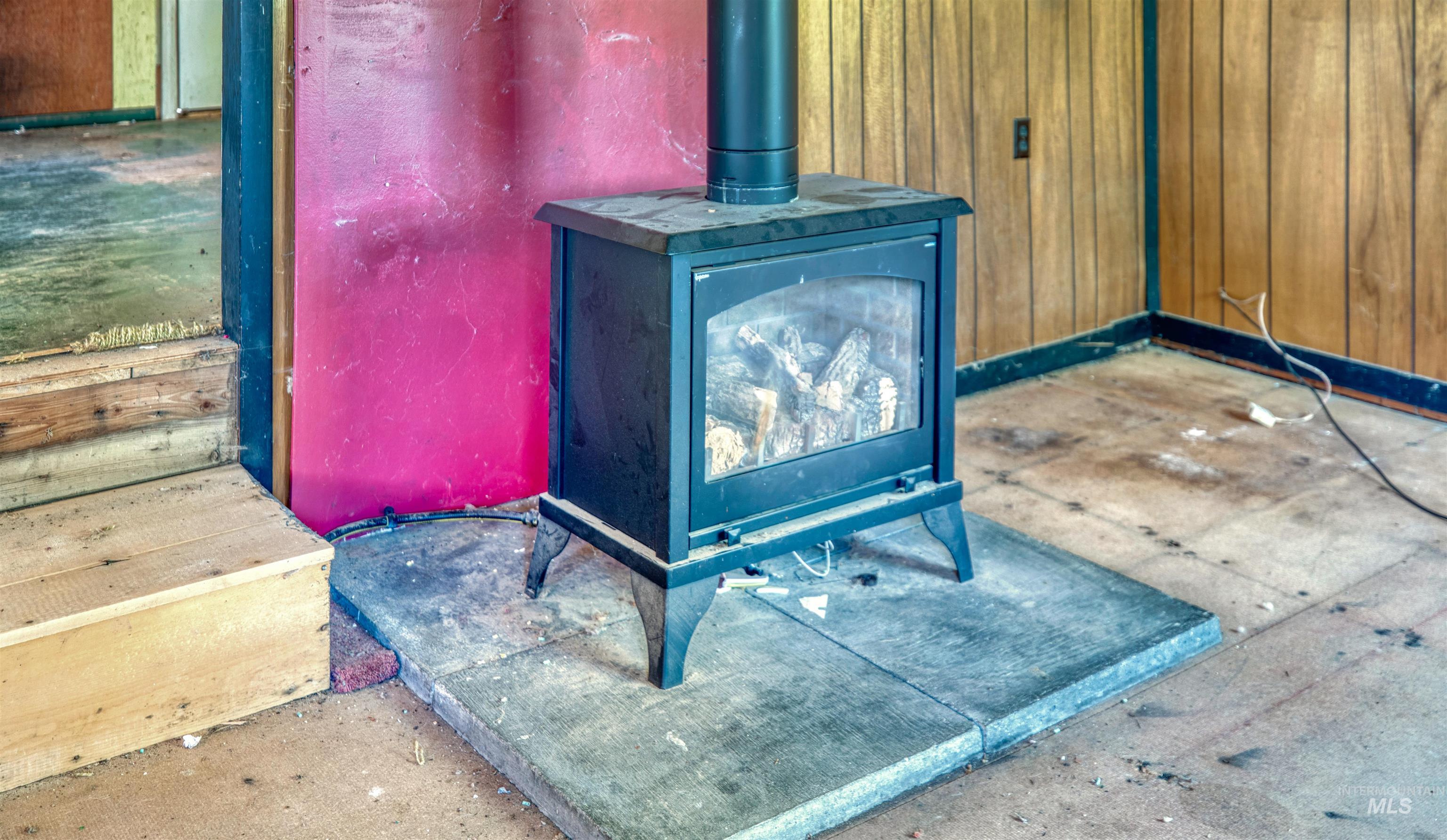 175 Ranft Road Placerville, ID 83666 - Photo 8 of 28 Detailed view of a wood stove and wooden walls