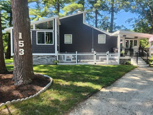 a view of a house with backyard and porch