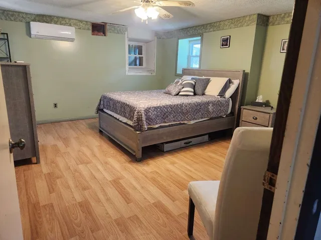 a bedroom with a bed and a dresser in it