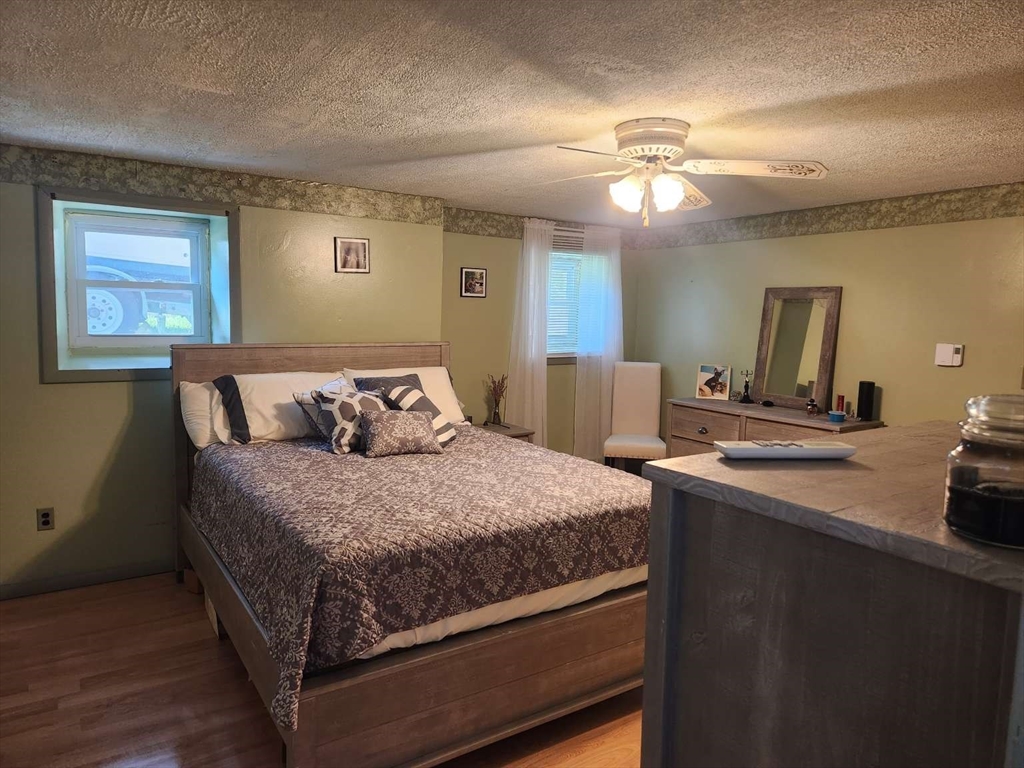 153 Off Pond Street Dunstable, MA 01827 - Photo 16 of 19 a bedroom with a large bed and a chandelier