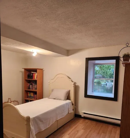 a bedroom with a bed and a wall painting