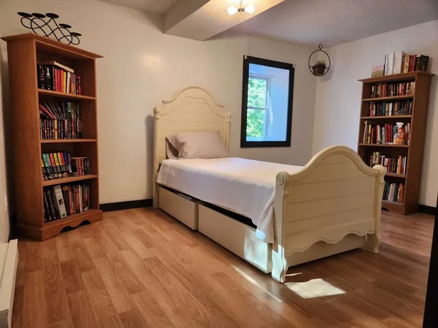 a bedroom with a bed and a book shelf