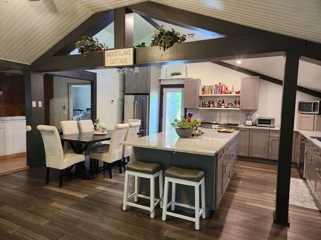 a large kitchen with a table and chairs