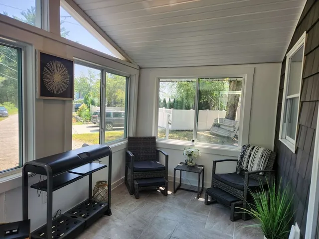 a view of a livingroom with furniture and a window