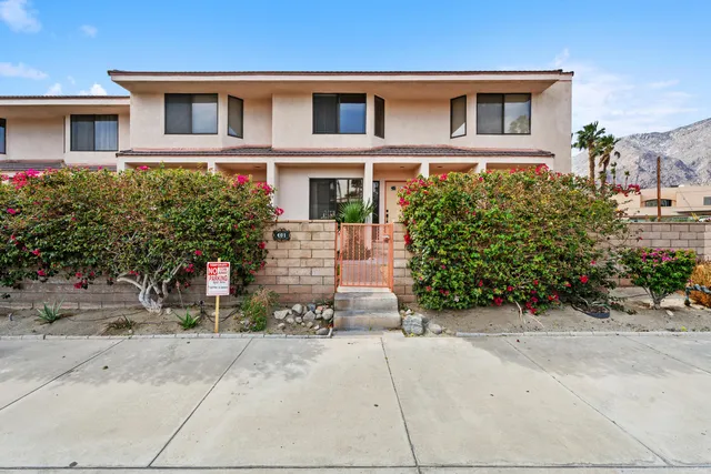 a front view of a house with a yard and a garage