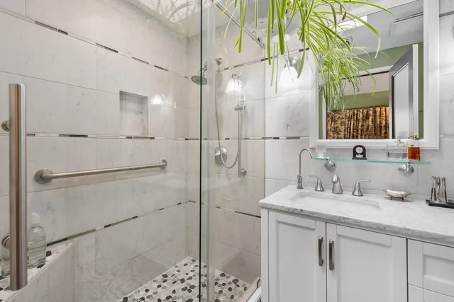 a bathroom with a double vanity sink mirror and shower