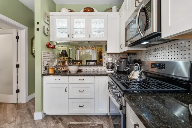 a kitchen with stainless steel appliances granite countertop a stove and a sink