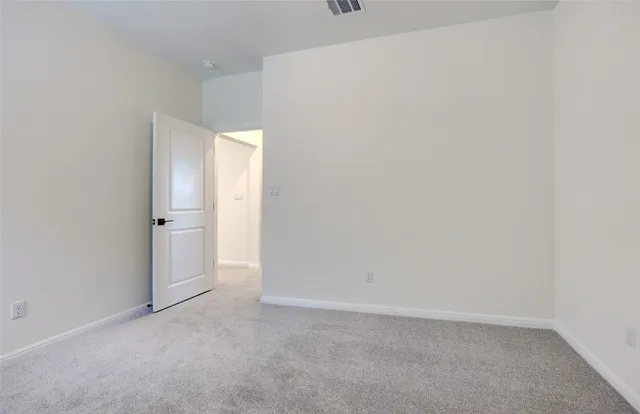 a view of an empty room and a window