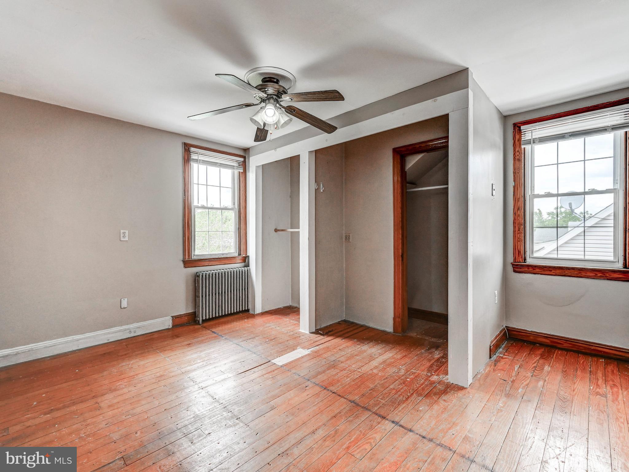 3206 Lynch Road Baltimore, MD 21219 - Photo 23 of 70 a view of empty room with wooden floor and fan