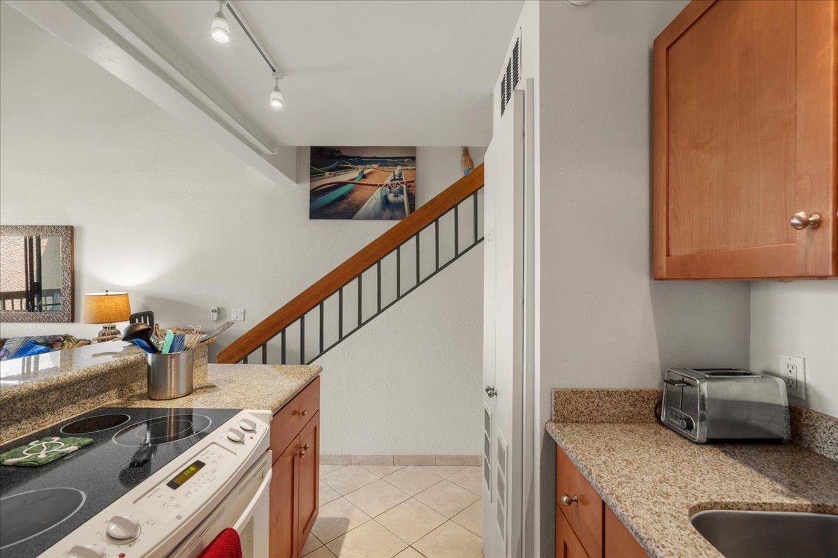 2191 South Kihei Road, Unit 2419 Kihei, HI 96753 - Photo 15 of 27 a kitchen with sink stove and cabinets