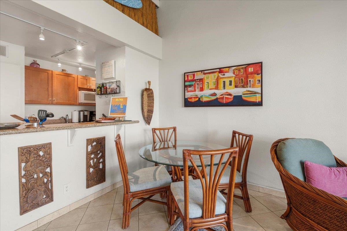 2191 South Kihei Road, Unit 2419 Kihei, HI 96753 - Photo 17 of 27 a dining room with furniture and wooden floor