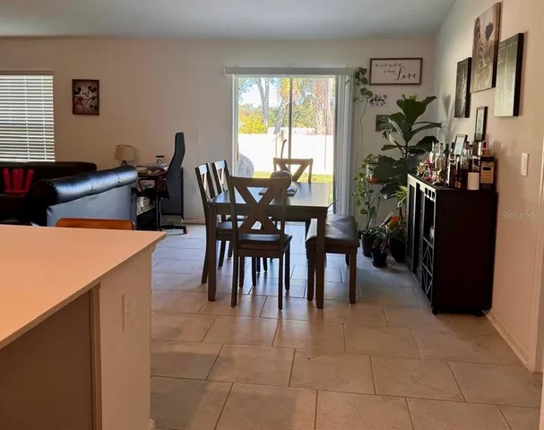 a dining room filled with furniture and window