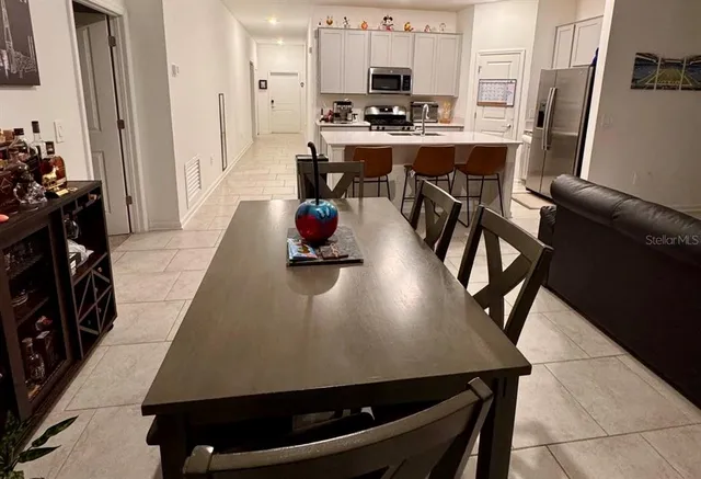 a view of a dining room with furniture and a flat screen tv