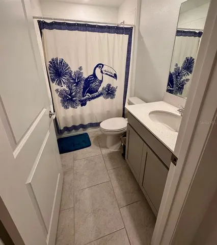 a bathroom with a double vanity sink mirror and toilet