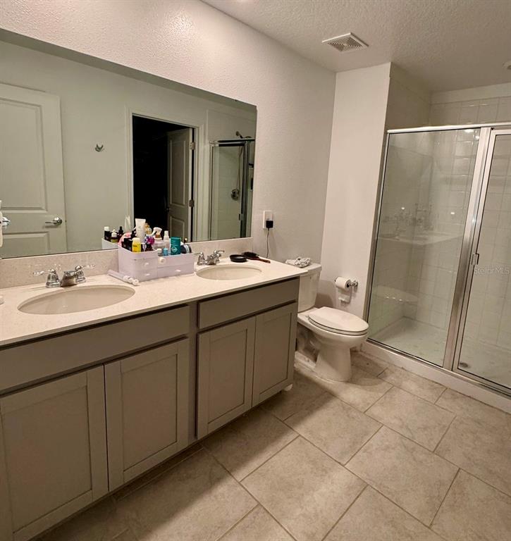 Undisclosed Address Leesburg, FL 34748 - Photo 10 of 11 a bathroom with a double vanity sink mirror and toilet