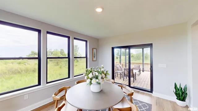 a dining room with furniture potted plants and wooden floor