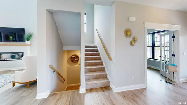 a view of entryway and hall with wooden floor