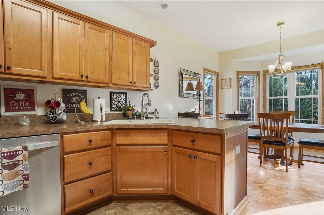 861 Susan Road Ravenna, OH 44266 - Photo 15 of 45 Kitchen featuring pendant lighting, sink, stainless steel dishwasher, kitchen peninsula, and a chandelier