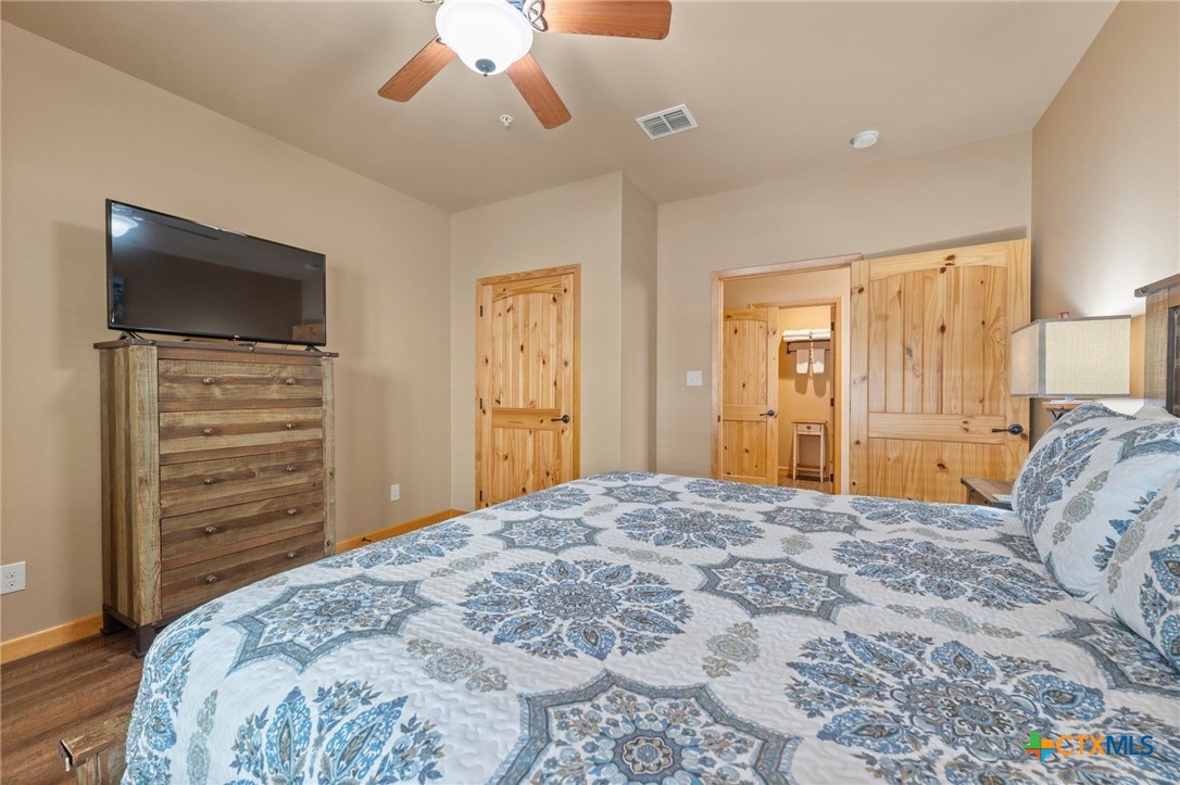 1554 Gruene Road, Unit A10 New Braunfels, TX 78130 - Photo 18 of 32 a bedroom with a bed and a flat screen tv