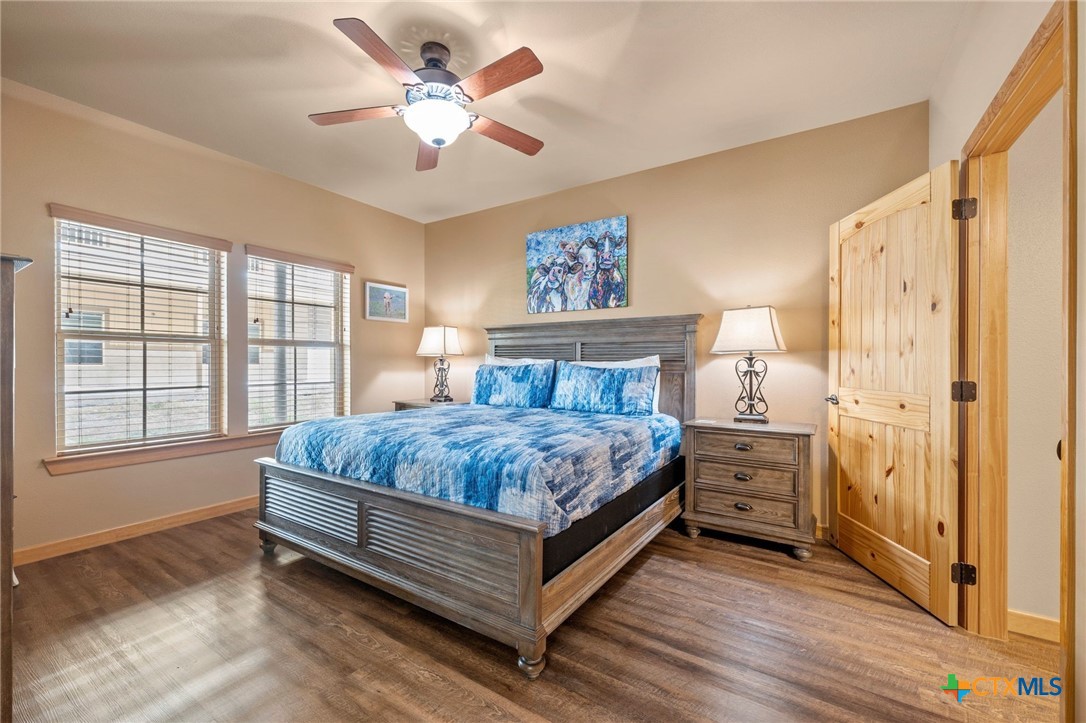 1554 Gruene Road, Unit A10 New Braunfels, TX 78130 - Photo 19 of 32 a bedroom with a bed chandelier and a window