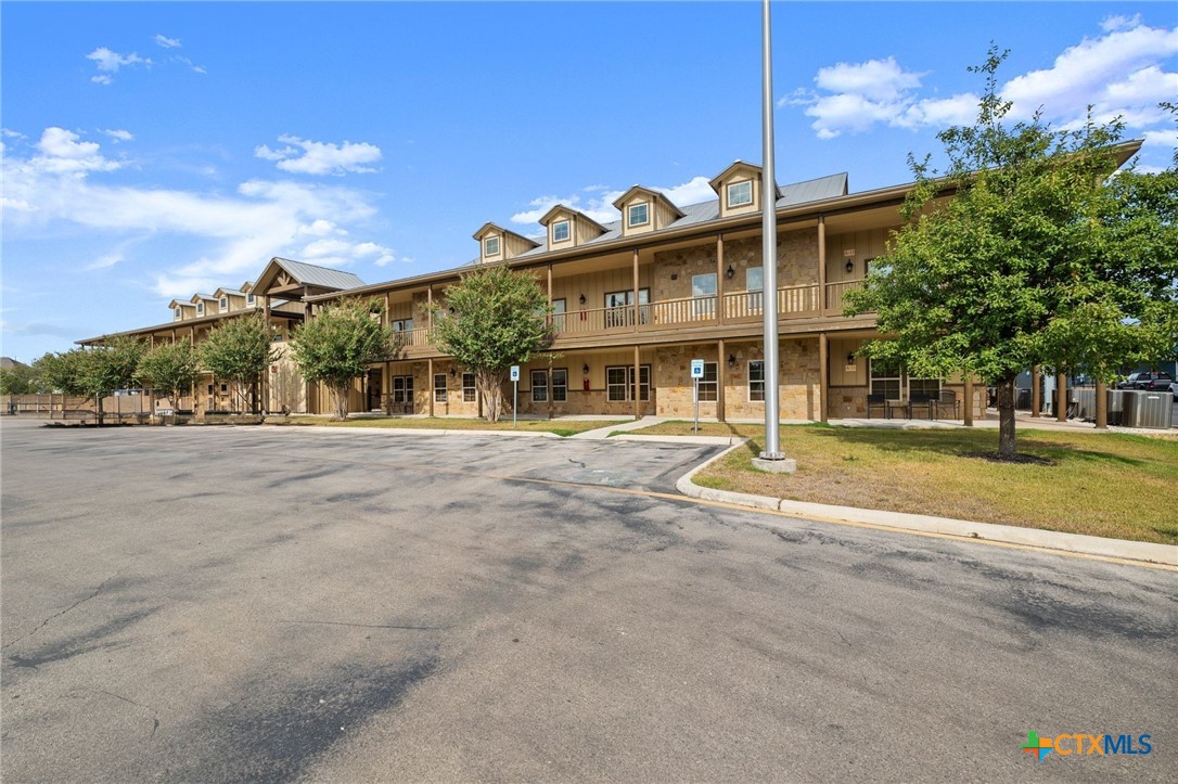 1554 Gruene Road, Unit A10 New Braunfels, TX 78130 - Photo 2 of 32 a front view of a house with a yard