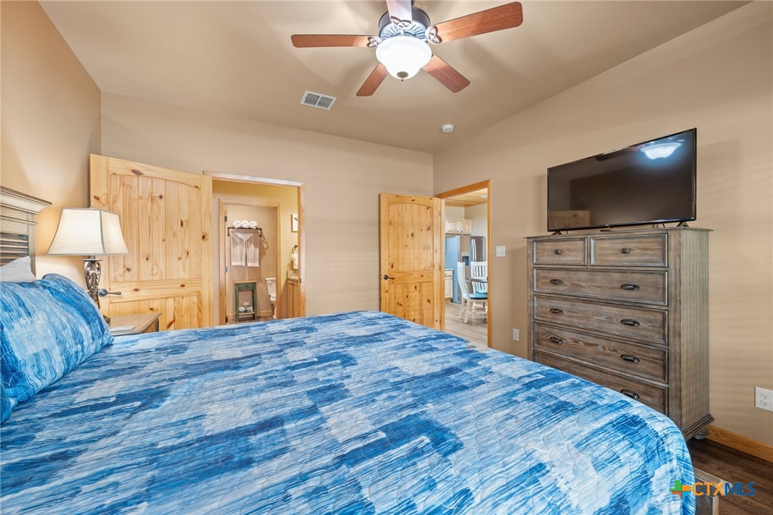 1554 Gruene Road, Unit A10 New Braunfels, TX 78130 - Photo 21 of 32 a bedroom with a bed and wooden floor