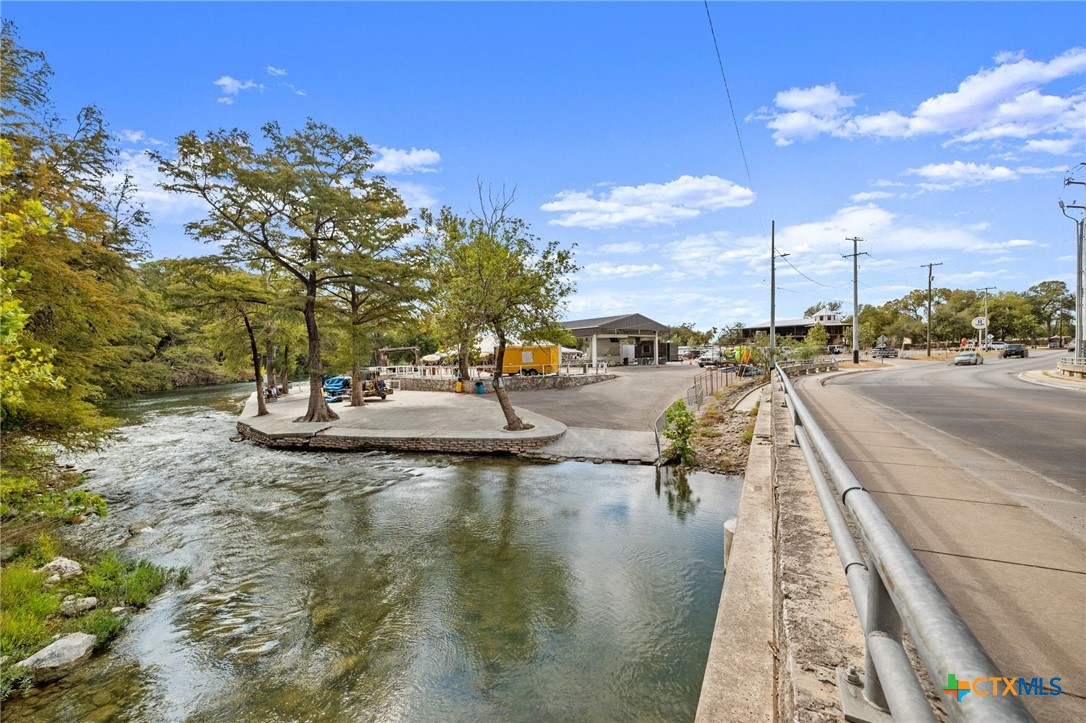 1554 Gruene Road, Unit A10 New Braunfels, TX 78130 - Photo 26 of 32 a view of a lake with a water fall