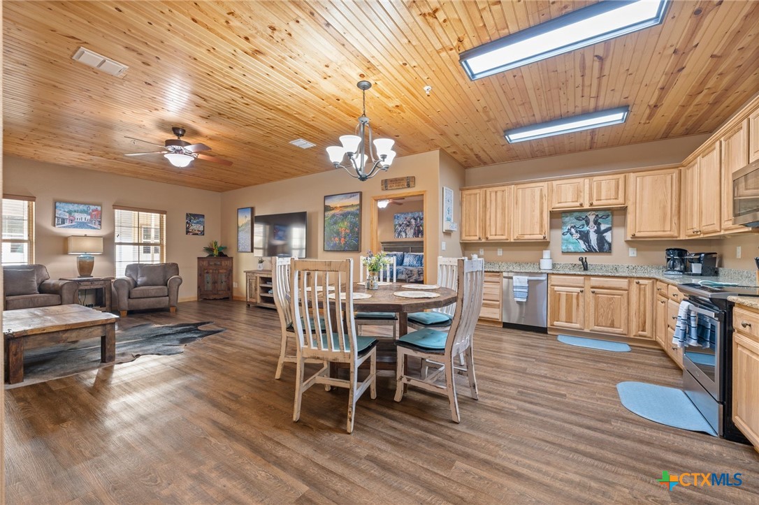 1554 Gruene Road, Unit A10 New Braunfels, TX 78130 - Photo 9 of 32 a view of a dining room with furniture and wooden floor