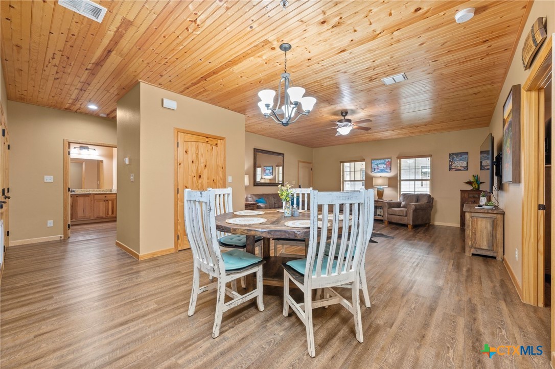 1554 Gruene Road, Unit A10 New Braunfels, TX 78130 - Photo 10 of 32 a view of a dining room with furniture window and wooden floor