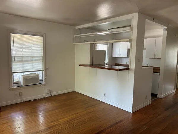 a view of a refrigerator in kitchen and wooden floor