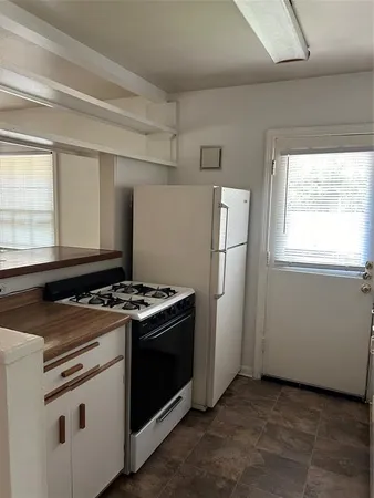 a kitchen with a stove and a refrigerator