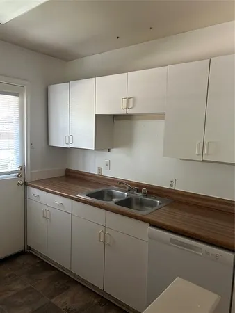 a kitchen with a sink and cabinets