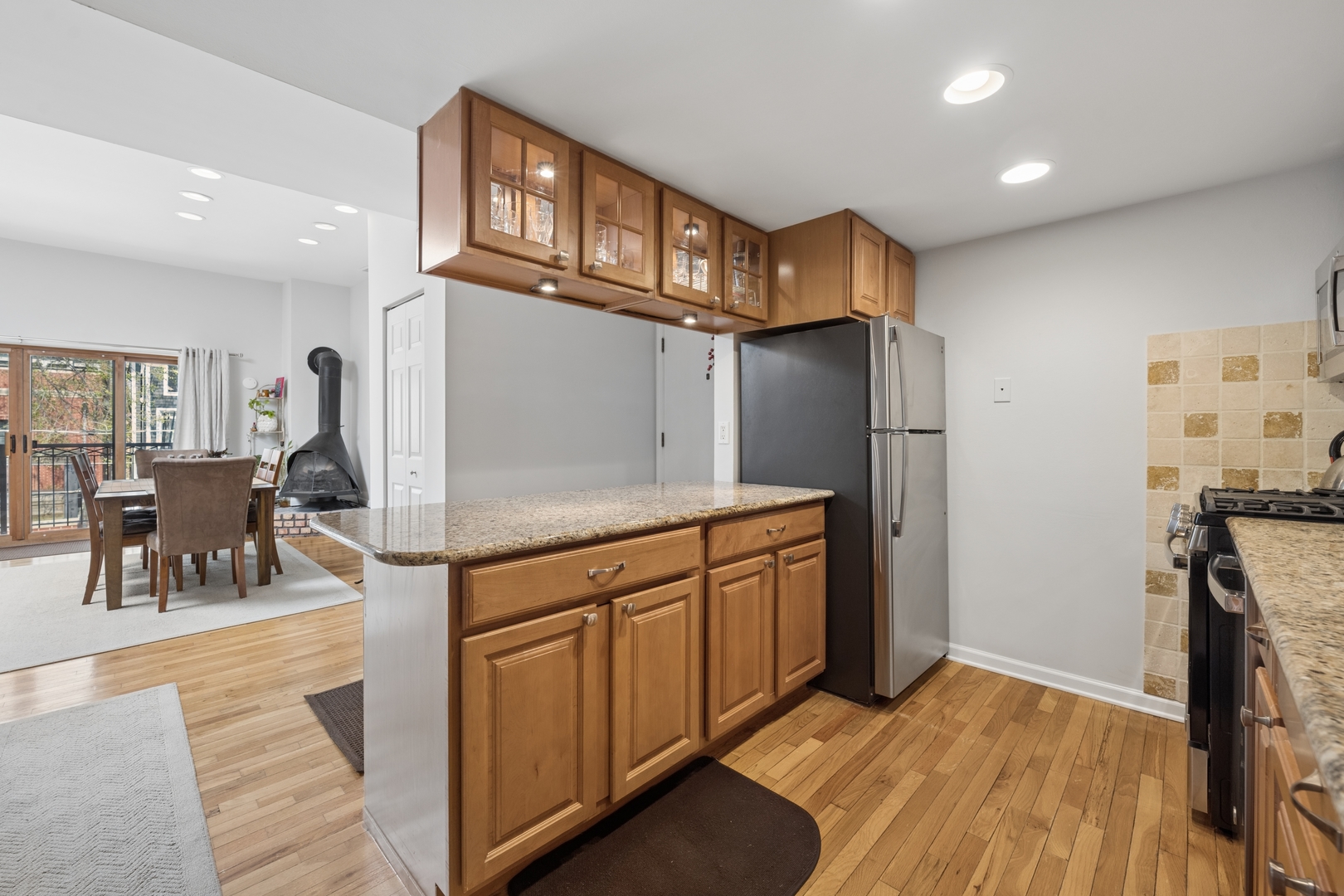 1122 West Altgeld Street, Unit 12 Chicago, IL 60614 - Photo 11 of 20 a kitchen with stainless steel appliances granite countertop a refrigerator and a stove top oven