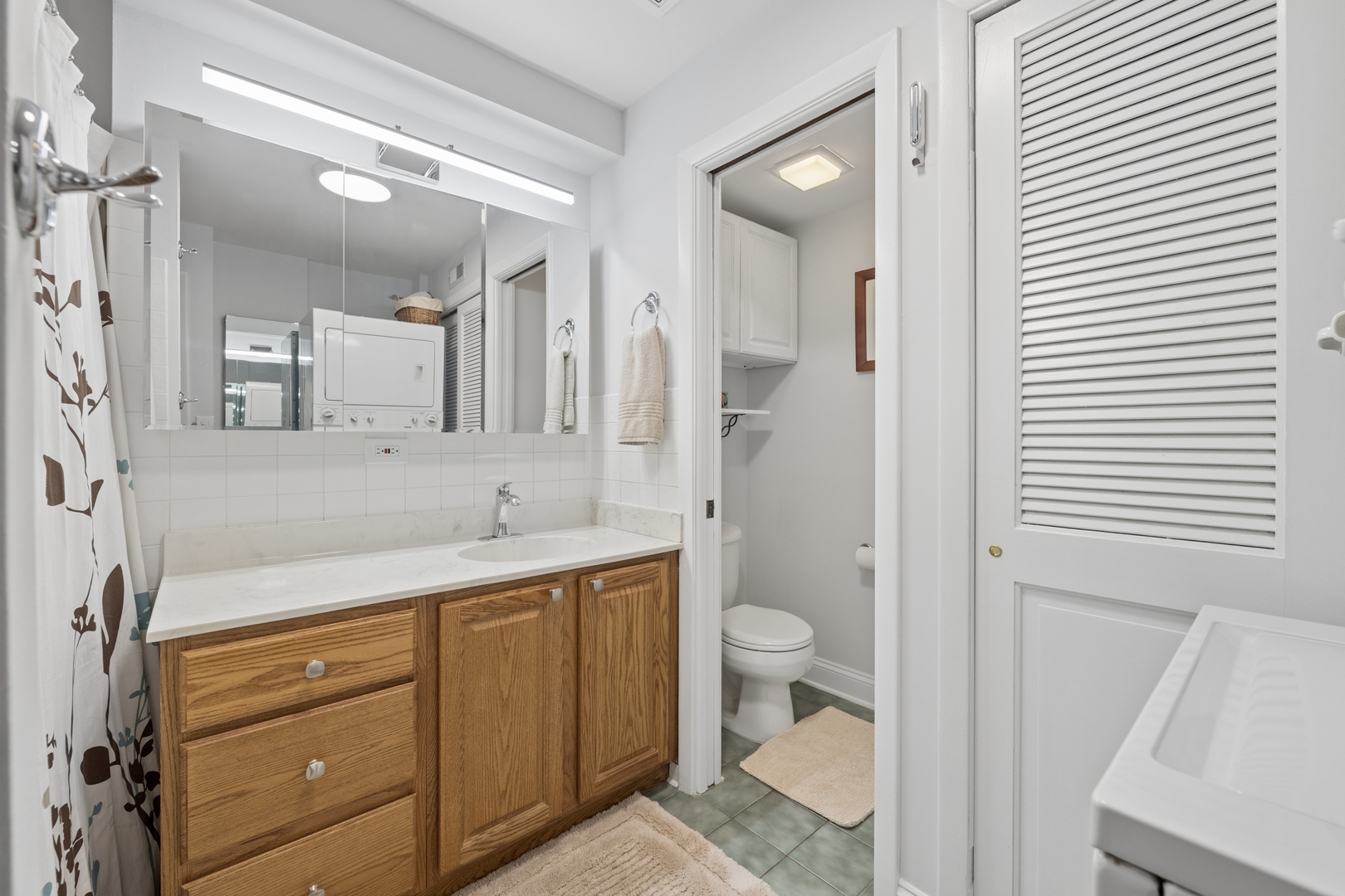 1122 West Altgeld Street, Unit 12 Chicago, IL 60614 - Photo 12 of 20 a bathroom with a granite countertop sink toilet and shower