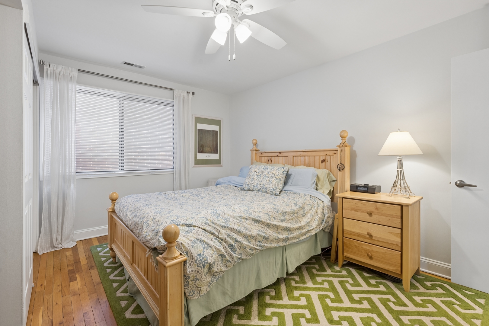 1122 West Altgeld Street, Unit 12 Chicago, IL 60614 - Photo 16 of 20 a bedroom with a bed and a lamp on the dresser