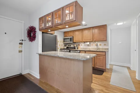 a kitchen with stainless steel appliances granite countertop a sink stove and cabinets