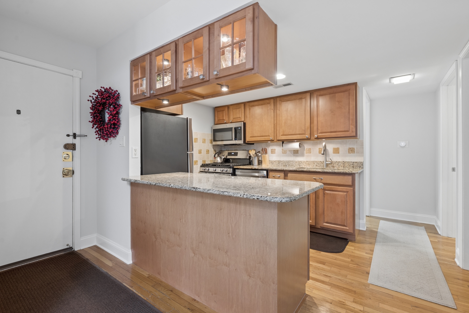 1122 West Altgeld Street, Unit 12 Chicago, IL 60614 - Photo 8 of 20 a kitchen with stainless steel appliances granite countertop a sink stove and cabinets