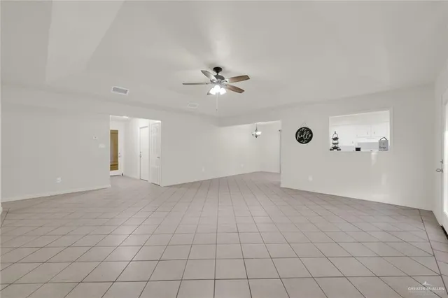 an empty room with fan and ceiling fan