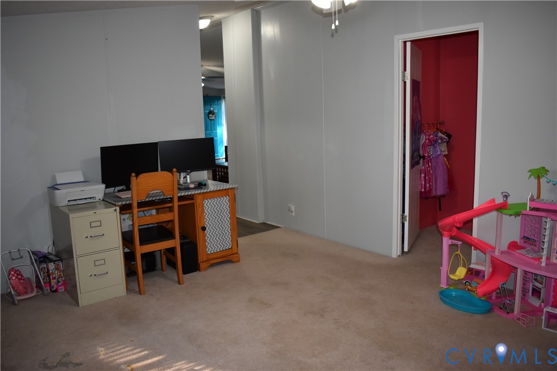 26049 Guy Place Road Courtland, VA 23837 - Photo 22 of 24 Interior room with light gray wall paneling and ne