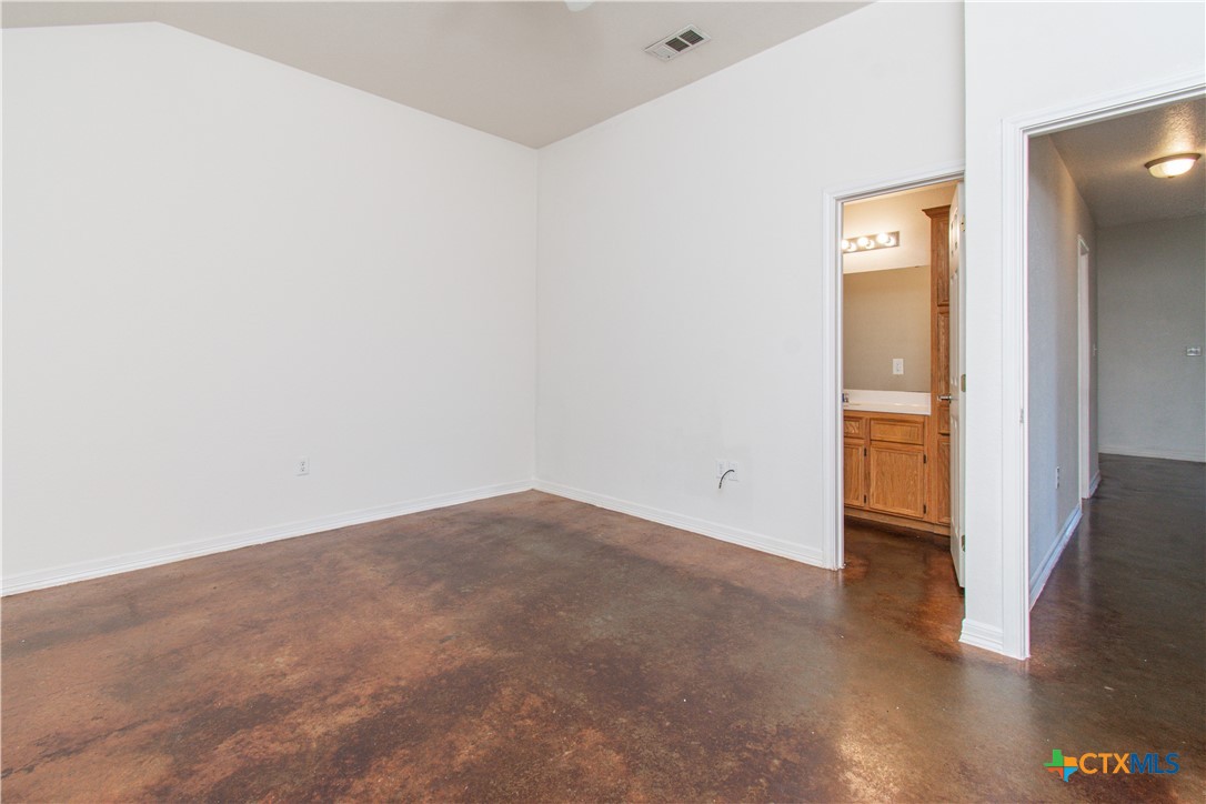 3104 Baldwin Loop, Unit A Killeen, TX 76549 - Photo 16 of 19 an empty room with wooden floor and windows