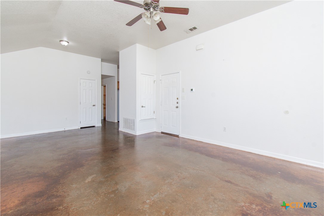 3104 Baldwin Loop, Unit A Killeen, TX 76549 - Photo 4 of 19 an empty room with a ceiling fan and carpet