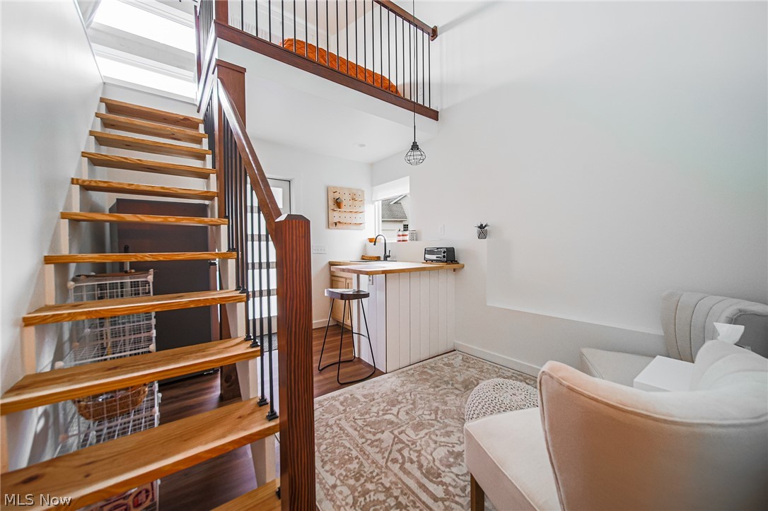9554 Dover Road Apple Creek, OH 44606 - Photo 39 of 45 Staircase featuring wood finished floors and a high ceiling