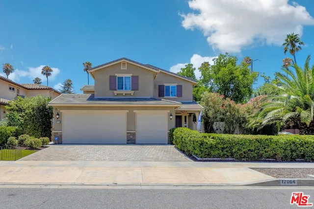 front view of house with potted plants