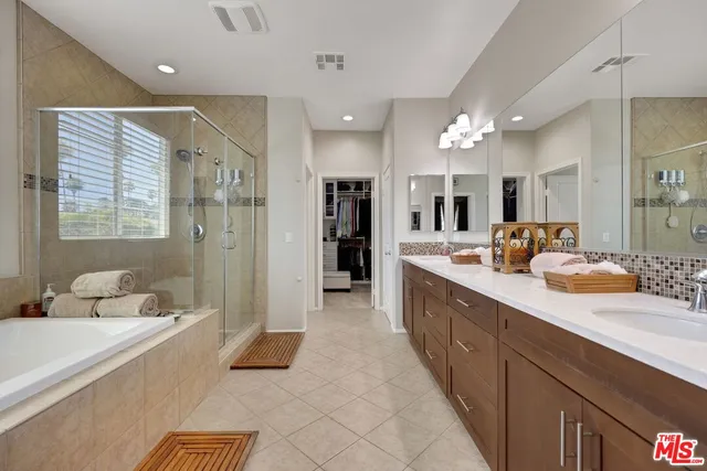 a large bathroom with a sink mirror and a shower