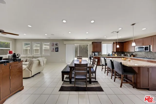 a living room with furniture a dining table and kitchen view