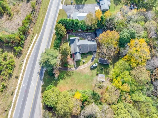 an aerial view of residential house with swimming pool and lawn chairs