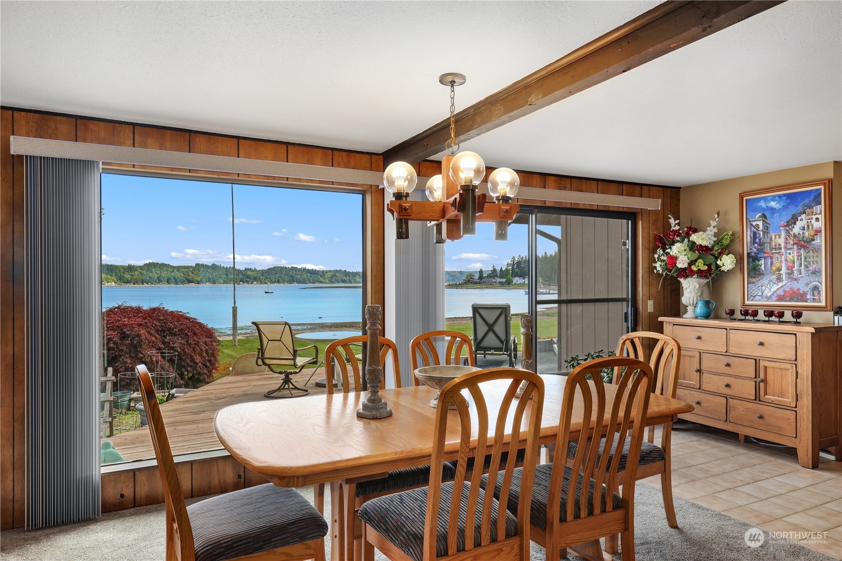 101 Northeast Sundstrom Road Belfair, WA 98528 - Photo 20 of 40 a dining room with furniture a flat screen tv and a floor to ceiling window