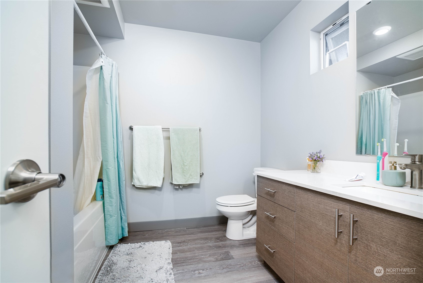 1882 Front Street, Unit 208 Lynden, WA 98264 - Photo 14 of 30 a bathroom with a toilet sink and mirror