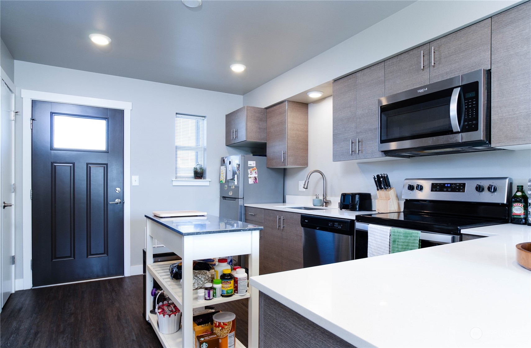 1882 Front Street, Unit 208 Lynden, WA 98264 - Photo 19 of 30 a kitchen with stainless steel appliances a stove microwave sink and cabinets