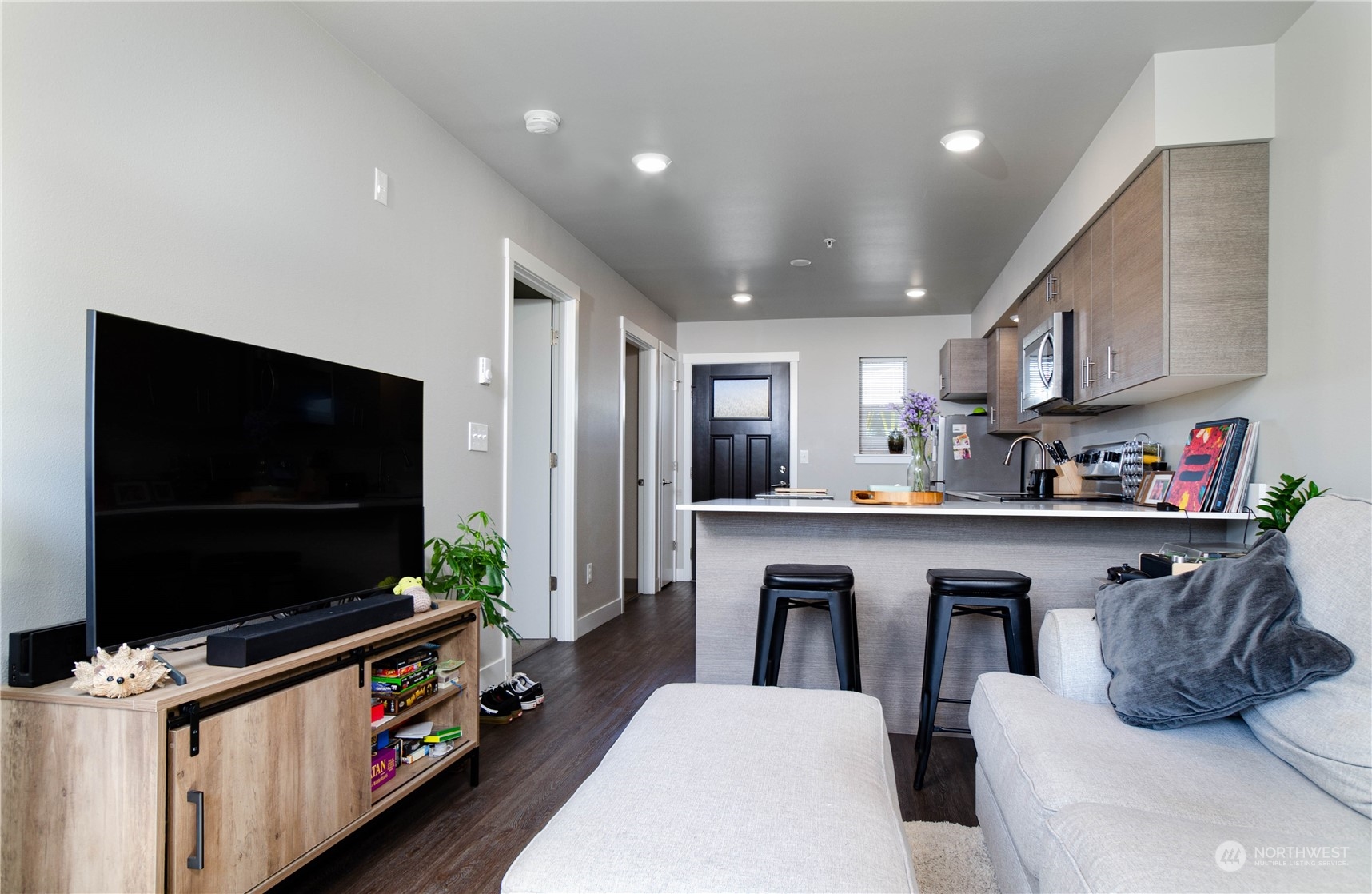 1882 Front Street, Unit 208 Lynden, WA 98264 - Photo 3 of 30 a living room with stainless steel appliances furniture and a flat screen tv